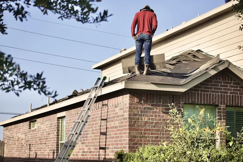Professional roofer working on a residential roof in Wahpeton